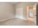 Well-lit bedroom featuring wood-style tile flooring, neutral paint, and large closet with bi-fold doors at 2811 S Asciano Ct, New Smyrna Beach, FL 32168