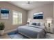 Bedroom featuring a large comfortable bed, blue accents, neutral paint and bright, natural light from the window at 2811 S Asciano Ct, New Smyrna Beach, FL 32168