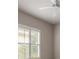 Bright bedroom featuring wood-style tile flooring, neutral paint, and modern ceiling fan with bright, natural lighting at 2811 S Asciano Ct, New Smyrna Beach, FL 32168