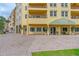 Building entrance with a covered awning and professional landscaping offering easy access to commercial and residential spaces at 2811 S Asciano Ct, New Smyrna Beach, FL 32168