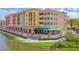 Exterior view of a mixed-use building with covered outdoor seating, providing a vibrant and welcoming atmosphere at 2811 S Asciano Ct, New Smyrna Beach, FL 32168
