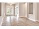 Bright foyer with tile flooring, showcasing an arched entryway and double doors with plantation shutters at 2811 S Asciano Ct, New Smyrna Beach, FL 32168