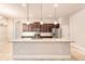 Bright kitchen with stainless steel appliances, granite countertops, and a large island at 2811 S Asciano Ct, New Smyrna Beach, FL 32168