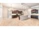 Well-lit kitchen with a large island, granite countertops, and dark wood cabinets at 2811 S Asciano Ct, New Smyrna Beach, FL 32168