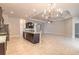 Spacious open kitchen with island and chandelier plus extra living space at 2811 S Asciano Ct, New Smyrna Beach, FL 32168