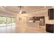 Open-concept living space blending the kitchen, dining, and living areas, featuring a large sliding glass door at 2811 S Asciano Ct, New Smyrna Beach, FL 32168