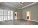 Primary bedroom with wood-look flooring, ceiling fan, recessed lights, and entry into bathroom and kitchen at 2811 S Asciano Ct, New Smyrna Beach, FL 32168