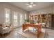 Well-lit office with built-in bookshelves, a comfortable chair, and French doors that provide a bright workspace at 2811 S Asciano Ct, New Smyrna Beach, FL 32168