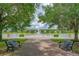 Scenic water view featuring benches, a stone walkway, and a tranquil fountain at 2811 S Asciano Ct, New Smyrna Beach, FL 32168