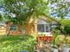 The backyard offers a serene screened patio, garden accents, and ample space for outdoor enjoyment at 2953 Autumn Run Pl, Orlando, FL 32822