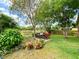 Backyard oasis with a patio set, colorful plants, and a serene view, perfect for outdoor relaxation at 2953 Autumn Run Pl, Orlando, FL 32822