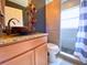 Stylish bathroom with a vessel sink, granite countertop, and tiled walk-in shower at 2953 Autumn Run Pl, Orlando, FL 32822