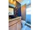 Bathroom featuring wood cabinets, a vessel sink, decorative mirror, and glass-enclosed shower at 2953 Autumn Run Pl, Orlando, FL 32822