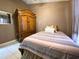 Bedroom featuring tile floors, neutral color walls, and a large decorative armoire at 2953 Autumn Run Pl, Orlando, FL 32822