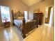Bright bedroom featuring a decorative metal bed frame, neutral color walls, and tile floors at 2953 Autumn Run Pl, Orlando, FL 32822