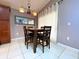 Cozy dining area with a dark wood table, four chairs, and elegant lighting at 2953 Autumn Run Pl, Orlando, FL 32822