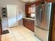 Modern kitchen featuring stainless steel appliances, granite countertops, and a white door at 2953 Autumn Run Pl, Orlando, FL 32822