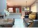 Open-concept living space with stainless steel appliances, dining area, and comfortable seating at 2953 Autumn Run Pl, Orlando, FL 32822