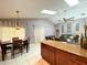 Open-concept living space featuring a modern kitchen, dining area, and comfortable seating at 2953 Autumn Run Pl, Orlando, FL 32822