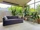 Covered patio with outdoor seating and many plants and trees surrounding the area at 2953 Autumn Run Pl, Orlando, FL 32822