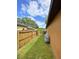 Side yard featuring a well-maintained lawn and tall wood fencing at 2953 Autumn Run Pl, Orlando, FL 32822