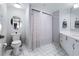 Bathroom with white tiled floor, toilet, vanity, and shower with curtain at 2967 S Atlantic Ave # 1404, Daytona Beach, FL 32118