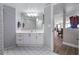 Bathroom featuring a white vanity and mirror next to an entry to another room at 2967 S Atlantic Ave # 1404, Daytona Beach, FL 32118