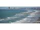Expansive beach view with ocean waves, distant buildings, and pier at 2967 S Atlantic Ave # 1404, Daytona Beach, FL 32118