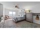 Bright bedroom with a large window, wooden furniture, and hardwood floors at 2967 S Atlantic Ave # 1404, Daytona Beach, FL 32118