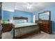 Serene bedroom with a king-size bed, wooden furniture, and a ceiling fan at 2967 S Atlantic Ave # 1404, Daytona Beach, FL 32118