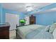 Blue bedroom with a king-size bed, hardwood floors, and ample storage at 2967 S Atlantic Ave # 1404, Daytona Beach, FL 32118