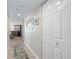 Well-lit hallway showcasing neutral walls, wood floors, and a spacious storage closet at 2967 S Atlantic Ave # 1404, Daytona Beach, FL 32118