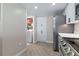 Modern kitchen and open pantry area with stainless steel appliances and wood-style floors at 2967 S Atlantic Ave # 1404, Daytona Beach, FL 32118