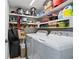 Laundry room featuring ample shelving and appliances at 2967 S Atlantic Ave # 1404, Daytona Beach, FL 32118