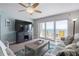 Living room boasting sliding glass doors to a balcony overlooking the ocean and comfortable seating at 2967 S Atlantic Ave # 1404, Daytona Beach, FL 32118