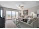 Bright living room featuring sliding glass doors that lead to a balcony with ocean views at 2967 S Atlantic Ave # 1404, Daytona Beach, FL 32118