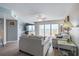 Cozy living room featuring light gray walls, wood floors, and sliding doors to a balcony at 2967 S Atlantic Ave # 1404, Daytona Beach, FL 32118