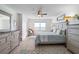 Bright main bedroom featuring neutral decor, ceiling fan and dressers with wood-look vinyl floors at 2967 S Atlantic Ave # 1404, Daytona Beach, FL 32118