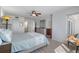 Bright main bedroom featuring neutral decor, ceiling fan and ensuite bathroom with wood-look vinyl floors at 2967 S Atlantic Ave # 1404, Daytona Beach, FL 32118