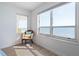 Bright sitting area with comfortable chair and large window view of the ocean at 2967 S Atlantic Ave # 1404, Daytona Beach, FL 32118