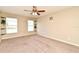 Spacious bedroom featuring neutral walls, carpet flooring, with two windows, and a ceiling fan with lights at 3025 Bonkirk Dr, Deltona, FL 32738