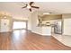 Open concept living space featuring wood floors and an adjacent kitchen with stainless appliances at 3025 Bonkirk Dr, Deltona, FL 32738