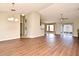 Open-concept living room features wood-look floors, neutral walls, vaulted ceilings, and an arched doorway at 3025 Bonkirk Dr, Deltona, FL 32738
