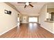 Bright living room featuring wood-look floors, neutral walls, vaulted ceilings, and an arched doorway at 3025 Bonkirk Dr, Deltona, FL 32738