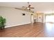 Open living room features vaulted ceilings, modern ceiling fan, and wood-look flooring at 3025 Bonkirk Dr, Deltona, FL 32738