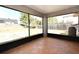 A view of the spacious screened porch with tile flooring and large screened windows overlooking the backyard at 3025 Bonkirk Dr, Deltona, FL 32738