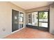 Screened porch with a sliding glass door and large windows offering natural light and backyard views at 3025 Bonkirk Dr, Deltona, FL 32738