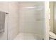 Contemporary shower with neutral tile, textured shower glass, and modern fixtures at 3025 Bonkirk Dr, Deltona, FL 32738
