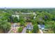 Aerial view showcasing the property nestled among lush greenery and neighborhood streets with mature trees at 333 N Kentucky Ave, Deland, FL 32724