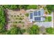 Overhead view of home featuring solar panels and a large backyard garden with circular planting beds at 333 N Kentucky Ave, Deland, FL 32724